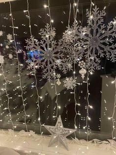 snowflakes and stars are hanging on the window