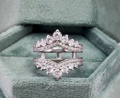 a diamond ring sits in a velvet box