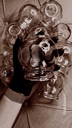 a bunch of empty wine glasses sitting on top of a tiled floor