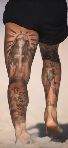 the legs and ankles of a man with tattoos