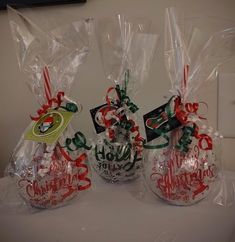 three wrapped christmas gifts sitting on top of a table