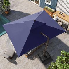 an umbrella sitting on top of a patio next to a pool