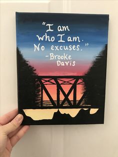 someone is holding up a card that reads, i am who i am no excess broke davis