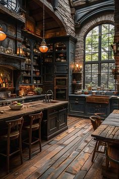 an old fashioned kitchen with wooden floors and dark blue cabinets, large windows, and lots of counter space