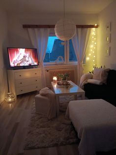 a living room filled with furniture and a flat screen tv