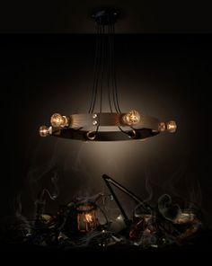 a chandelier hanging over a pile of junk in the dark with lights on