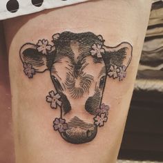 a cow with flowers on it's thigh is seen in this tattoo photo taken by the owner