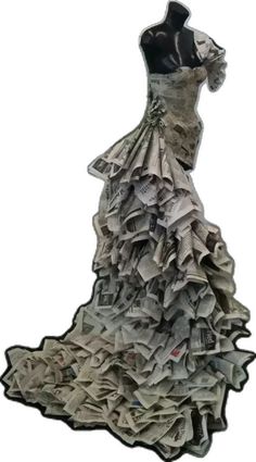 a dress made out of newspapers sitting on top of a mannequin