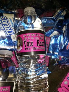 a bottle of water sitting on top of a pile of plastic wrap around it's sides