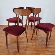 four chairs and a table in a room with wood flooring on top of it