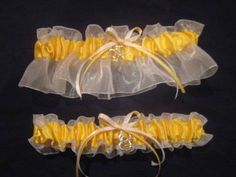 Welcome to GarterShop! Yellow satin on white organza, coordinating bow, and your choice of a silver toned or brass fireman helmet charm. (Double heart charm shown in first two pictures, specified charm is in third and fourth.) Choose a keepsake only or a set which includes a toss. Regular garters stretch to 22", plus size stretch to 30". Other charms available.  Please contact me.  I'd love to customize for you. Yellow And White Wedding, Yellow White Wedding, Fireman Helmet, Prom Garters, Wedding Musicians, Firefighter Wedding, Wedding Plus Size, Cinderella Slipper, Bridal Garters Set