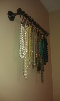 there is a rack with beads hanging on the wall