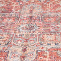 an old rug with many different colors and patterns on it, including red, orange, blue