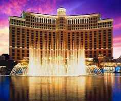 the fountains in front of the hotel are lit up