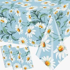 the table cloth has daisies on it