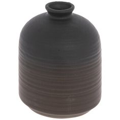 a black vase sitting on top of a white table