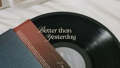 an old record with the words better than gesterday on it next to a cup of coffee