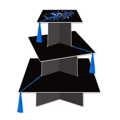 three stacks of black and grey paper with blue tassels on each end, one in the shape of a graduation cap