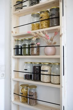 an open pantry filled with lots of different types of food in glass jars and containers