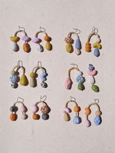 several different types of earrings hanging from strings