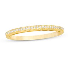 a yellow gold wedding band with white diamonds on the top and bottom half of it