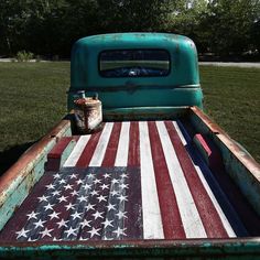 an old truck with the american flag painted on it