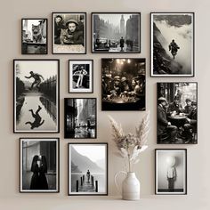 black and white photographs are hung on the wall above a vase with a flower in it