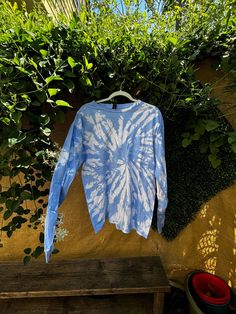 Embrace the perfect blend of comfort and style with this Handmade Blue & White Tie-Dye Cotton Shirt! Crafted on a high-quality, size Large Gildan tee, this shirt is made from 100% soft cotton, ensuring a comfortable fit for any occasion. Key Features: Vibrant Blue & White Tie-Dye: Each shirt is hand-dyed, making every piece truly one-of-a-kind. The eye-catching pattern is perfect for standing out at festivals, beach days, or casual outings. Size Large (Gildan): This unisex tee fits true to size and is made by Gildan, known for its durable and soft cotton fabric. Versatile & Stylish: Whether you're looking to add a boho vibe to your wardrobe or searching for the perfect gift, this tie-dye shirt is a great choice. Care Instructions: To maintain the vibrant colors, wash in cold water and air Blue Relaxed Fit Comfortable T-shirt, Blue Crew Neck Comfortable Tops, Comfortable Blue Crew Neck Tops, Blue Relaxed Fit Athleisure Top, Blue Washed Cotton Tops, Blue Washed Cotton Top, Blue Comfortable Relaxed Fit T-shirt, Comfortable Soft-washed Blue Tops, Soft-washed Long Sleeve Tops For Summer