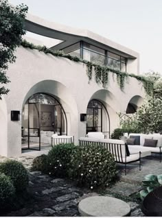 an outdoor living area with couches and tables