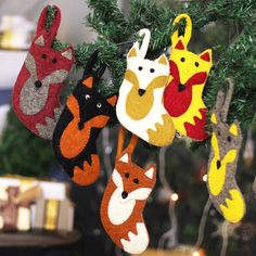 several felt ornaments hanging from a christmas tree