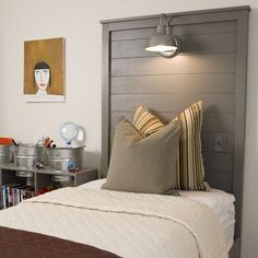 a bedroom with a bed, nightstand and pictures on the wall