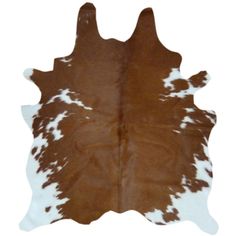 a brown and white cowhide rug on a white background