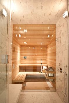 a bathroom with a sauna in the middle and lights on all over it's walls