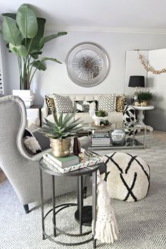 a living room filled with furniture and plants