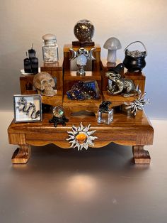 a wooden table topped with assorted items on top of a white floor next to a wall