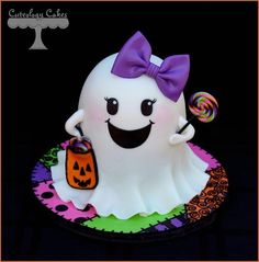 a cake decorated to look like a ghost with a candy bag and candies in it