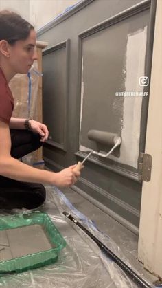 a woman is painting the side of a door