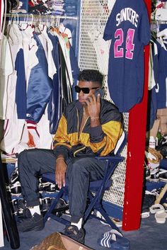 a man sitting in a chair talking on a cell phone