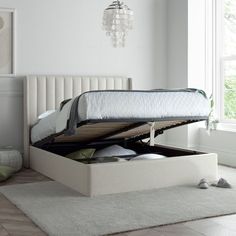 a bed that is sitting in the middle of a room next to a rug on the floor