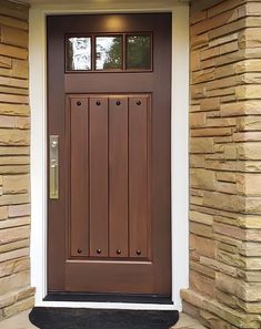 a brown front door on a brick house