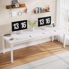 two white desks with numbers on them in front of a window and wooden floor