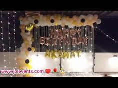 balloons and streamers decorate the entrance to a birthday party