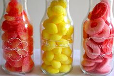 three glass jars filled with different colored candies