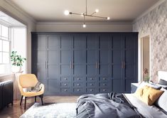 a bedroom with blue cabinets and a white rug