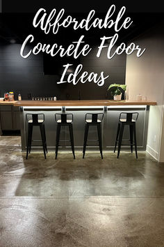 A modern bar area with dark stained concrete floors, black bar stools, and a sleek black backsplash, with the text "Modern Concrete Floor Ideas" overlaid on the image. The polished concrete floor adds a sophisticated and contemporary look to the space. Concrete Floor Ideas, Water Based Concrete Stain, Wellness Center Design, Concrete Stains, Stained Concrete Floors, Flooring Options Durable, Concrete Staining, Sleek Bar, Concrete Stain