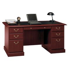 an office desk with two drawers and a laptop on it