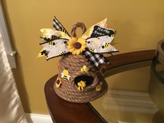 a brown basket with yellow flowers and bees on it