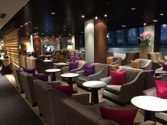 an empty lounge with many chairs and tables