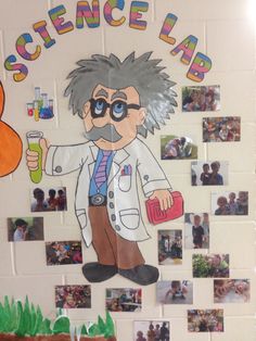 a science lab themed bulletin board with pictures on the wall and people in the background