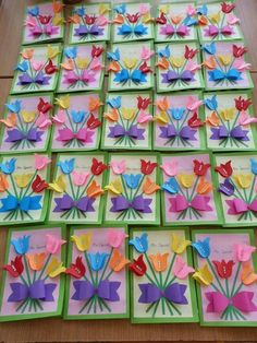 colorful paper flowers are arranged in rows on the table